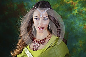 Beautiful fashion Indian woman portrait with oriental accessories earrings. Arabic girl with beauty jewels. Hindu model with