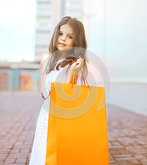 Beautiful fashion little girl with shopping bag