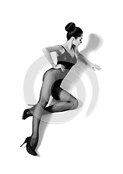 Beautiful fashion model in black swimsuit and hosiery. Young and beautiful woman posing in studio. photo