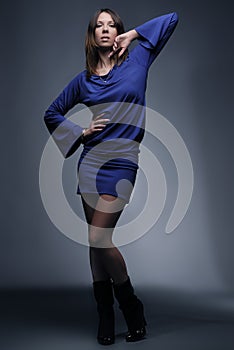 Beautiful fashion model in blue on dark background