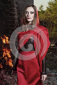 Beautiful fashion model girl wearing a red long skirt and a red