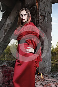 Beautiful fashion model girl wearing a red long skirt and a red
