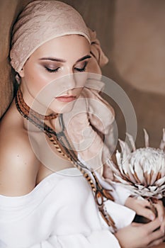 Beautiful fashion model posing in boho style clothes