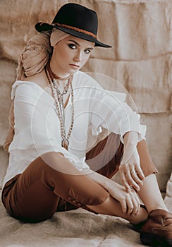 Beautiful fashion model posing in boho style clothes