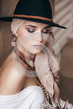 Beautiful fashion model posing in boho style clothes