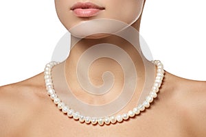 Beautiful fashion pearls necklace on the neck. Jewellery and bijouterie photo