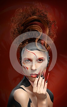Beautiful fashion woman color face art fenix style and nail desi