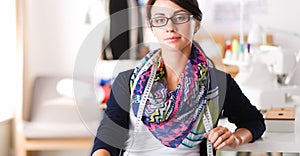 Beautiful fashion woman designer standing in studio