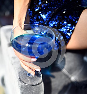 Beautiful fashion woman drink blue glitter martini cosmopolitan cocktail