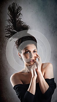 Beautiful fashion woman model with chignon on her head posing in studio