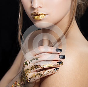 Beautiful Fashion woman model face portrait with gold lipstick and black nails. Glamour girl with bright makeup. Beauty