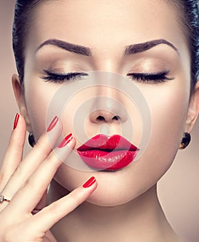 Beautiful fashion woman with red lipstick and red nails