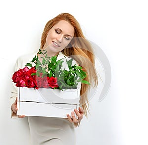 Beautiful fashion woman sitting with a bouquet of roses in pretty box