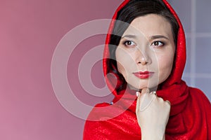 Beautiful fashionable Asian woman with a red headscarf on her head