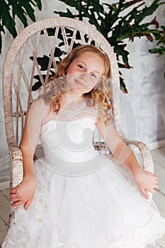 Beautiful fashionable girl 10 years old in a white dress