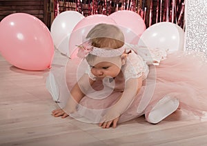 Beautiful fashionable little baby in pink dress. little princess poses like a doll