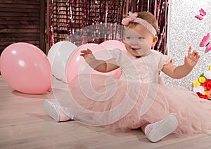 Beautiful fashionable little baby in pink dress. little princess poses like a doll