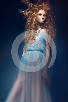 Beautiful fashionable red-haired girl in transparent dress, mermaid image with creative hairstyle curls. Fashion beauty style.