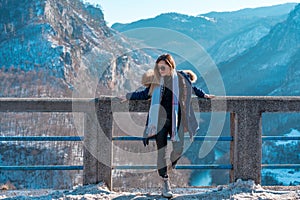 Beautiful fashionable young girl posing with Tara river Canyon in the background