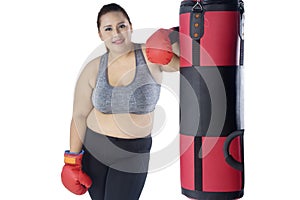 Beautiful fat woman leaning on a bag boxing