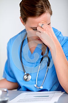 Beautiful fatigue doctor woman with a stethoscope
