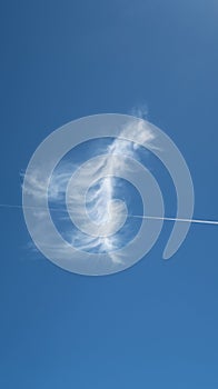 Beautiful feathery cloud looking like hanging on a clothesline