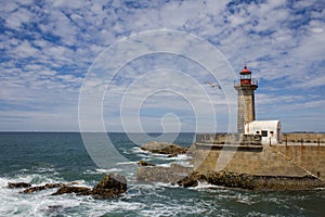 Beautiful Felgueiras Lighthouse on Atlantic Ocean in Porto, Portugal. Beach do Carneiro photo