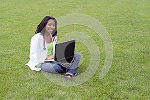 Beautiful female African American college student on campus wearing whitecoat