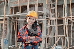 Beautiful female asian contractors wearing safety helmets with crossed hands