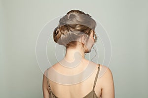 Beautiful female back with bridal hairdo, woman head and back on white background