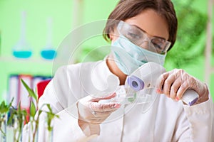 The beautiful female biotechnology scientist chemist working in lab