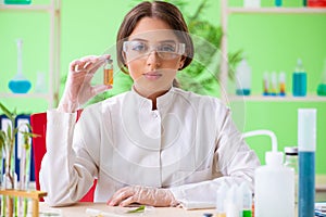 The beautiful female biotechnology scientist chemist working in lab