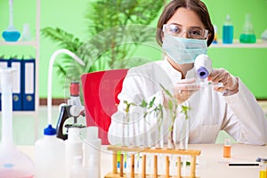 The beautiful female biotechnology scientist chemist working in lab