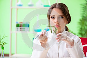 The beautiful female biotechnology scientist chemist working in lab