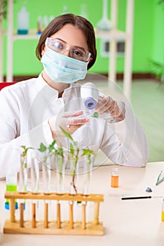 The beautiful female biotechnology scientist chemist working in lab