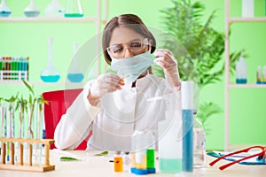 The beautiful female biotechnology scientist chemist working in lab