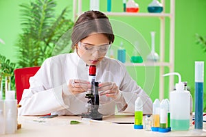 The beautiful female biotechnology scientist chemist working in lab