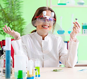 Beautiful female biotechnology scientist chemist working in lab