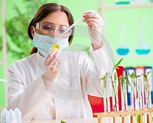 Beautiful female biotechnology scientist chemist working in lab