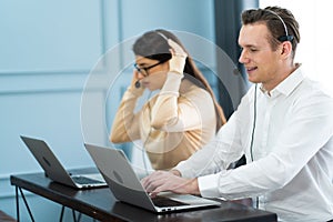 Beautiful female call center operator working on computer in office. Communication support for callcenter and customer service