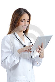 Beautiful female doctor browsing a tablet pc while she is working photo