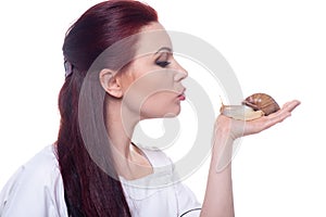 Beautiful female doctor cosmetologist with Akhatina snail in her hands offers collagen mask, snail mucus, skin rejuvenation