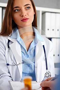 Beautiful female doctor hold in arms pad offering sign