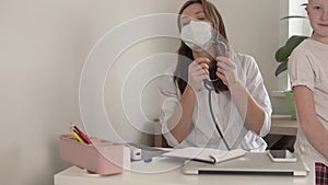 A beautiful female doctor measures the saturation of oxygen in a child