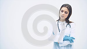 Beautiful female doctor putting stethoscope over her neck, sighing, massaging her temples, looking tired.