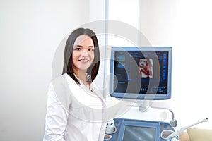 Beautiful female doctor sitting in her office near ultrasound sc