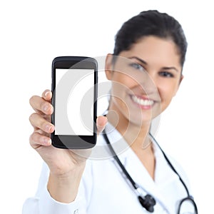Beautiful female doctor smiling and showing a blank smart phone screen isolated