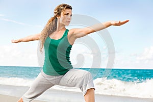 Beautiful female doing yoga warrior pose