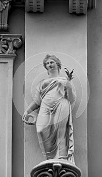 Beautiful female effigy holding a plant and a flower crown