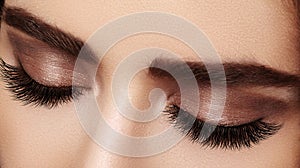 Beautiful female eye with extreme long eyelashes, black liner makeup. Perfect make-up, long lashes. Closeup fashion eyes